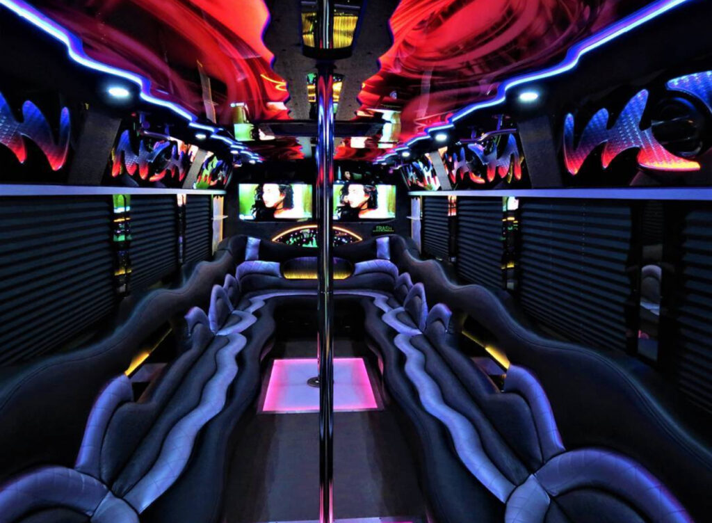 Luxury party bus interior with vibrant lights, cozy seating, and a dance pole, showcasing the ultimate Party Bus Budapest Stag experience.