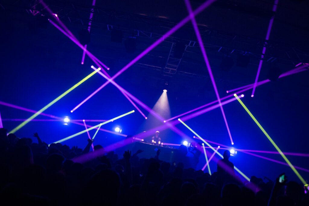 Vibrant nightclub scene with blue laser lights and dancing crowd, capturing the energy of Budapest's legendary nightlife