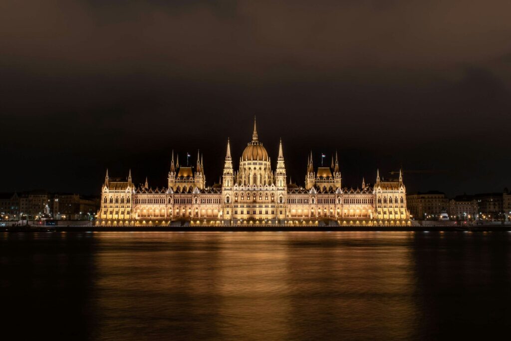 lluminated Hungarian Parliament at night seen from stag boat cruise Budapest
