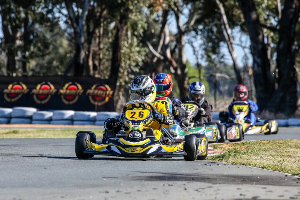 Group of racers competing on a go-kart track, showcasing the excitement of go kart Budapest stag activities.