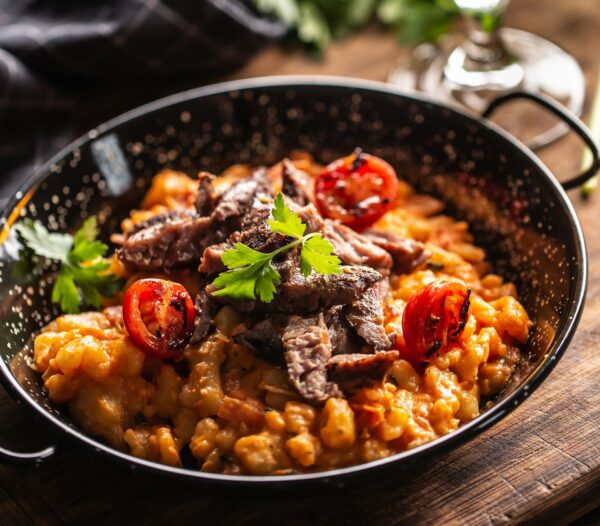 Bowl of hearty Hungarian goulash served with fresh bread, showcasing the traditional flavors of dinner Budapest stag activities.