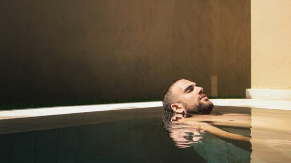 Man relaxing in a tranquil pool, capturing the rejuvenating experience of a spa visit during a Budapest stag detox activity.