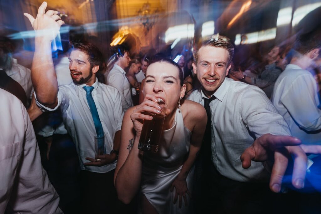 "Friends celebrating with drinks and dancing, part of unforgettable Budapest stag party packages
