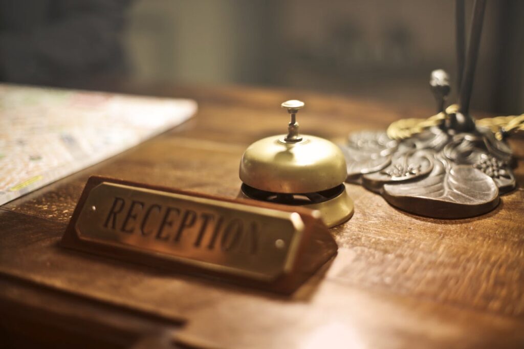 Classic hotel reception desk with a service bell, symbolizing the start of a smooth and enjoyable stay in Budapest