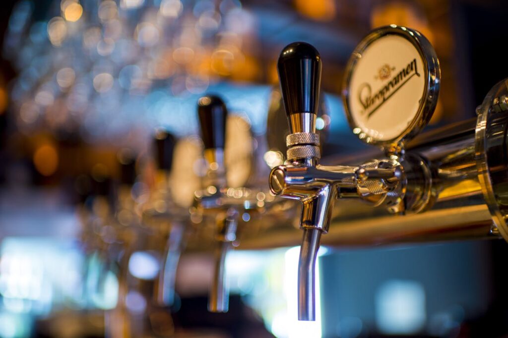 Close-up of beer taps in a bar, a popular feature in Budapest stag party packages for nightlife enthusiasts.