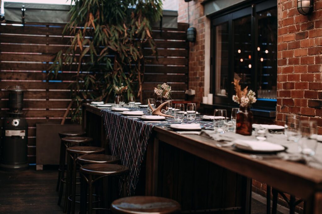 A stylishly arranged dining table in a warm and inviting setting, ready for a group gathering or celebration.