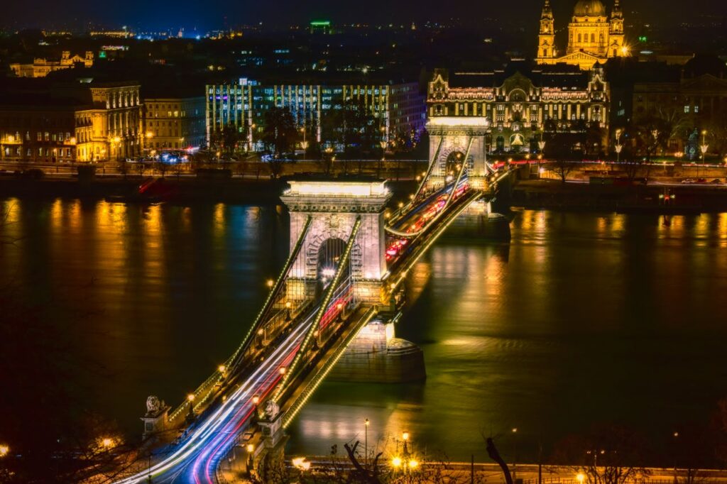 Night view of the illuminated Chain Bridge in Budapest, showcasing the city's stunning architecture and vibrant nightlife atmosphere.